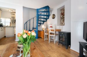 Courtyard Cottage Lounge and spiral stairs. A pet friendly holiday cottage.